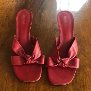 Worn, red Michelle D leather heeled sandal.